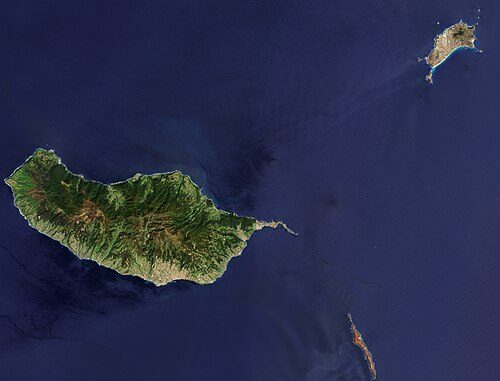 Satellite image of the Madeira archipelago by the Copernicus Sentinel-2 stellite, with Porto Santo on the top right, Madeira island on the center, and the Desertas islands at the bottom, with the Chão islet at the top and Deserta Grande island at the
