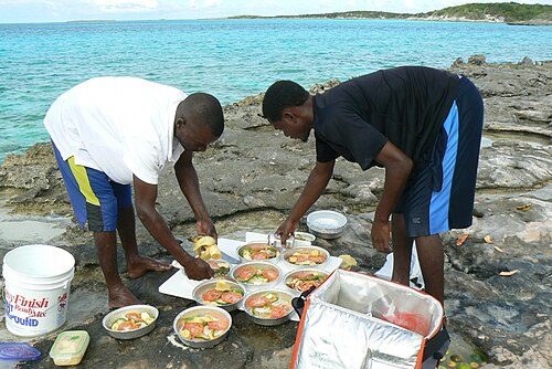 Men preparing a meal with caught fish