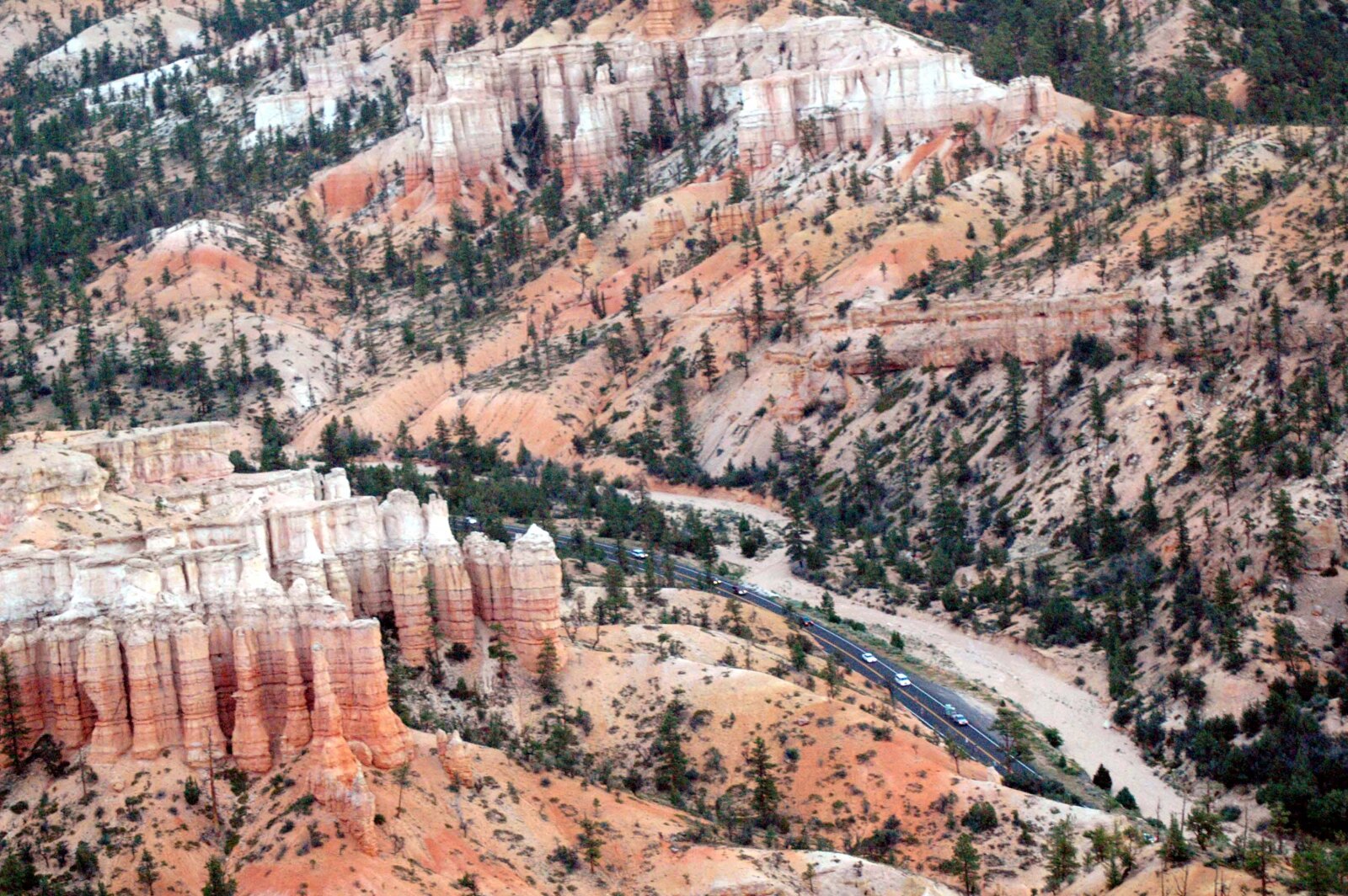 Cars on Scenic Byway 12 winding between the hoodoos of Red Canyon, near Bryce Canyon