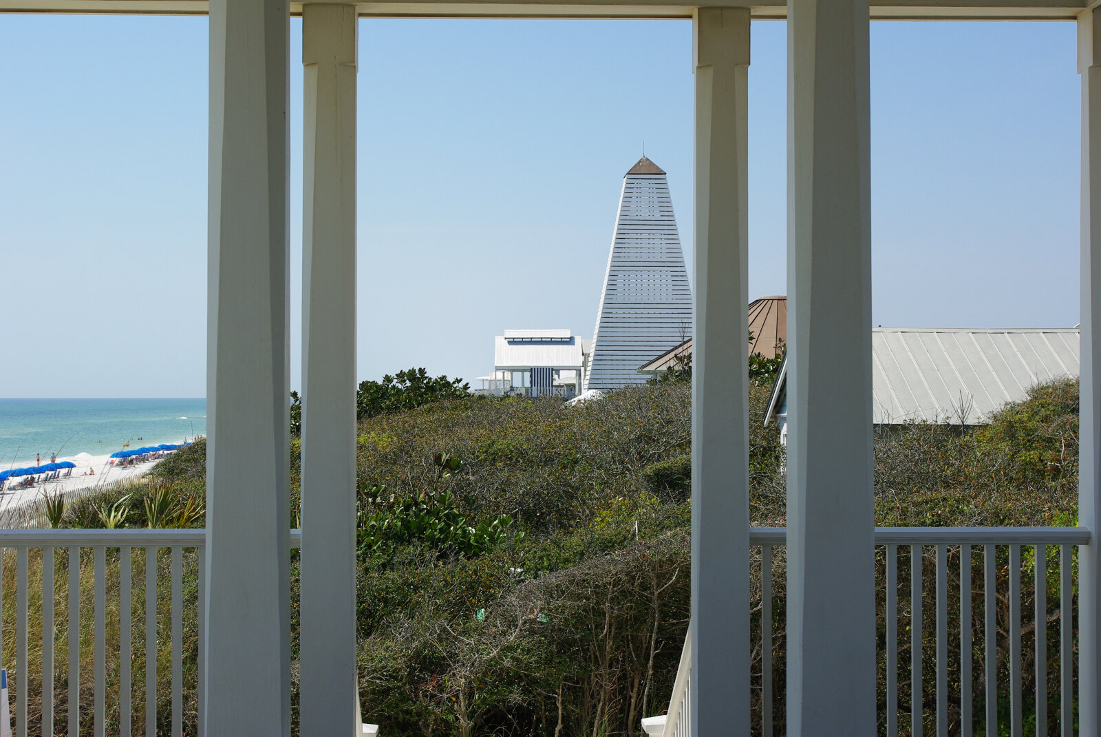 Seaside's beach pavilion and the Gulf seen from a porch, the town's white wooden architecture around it